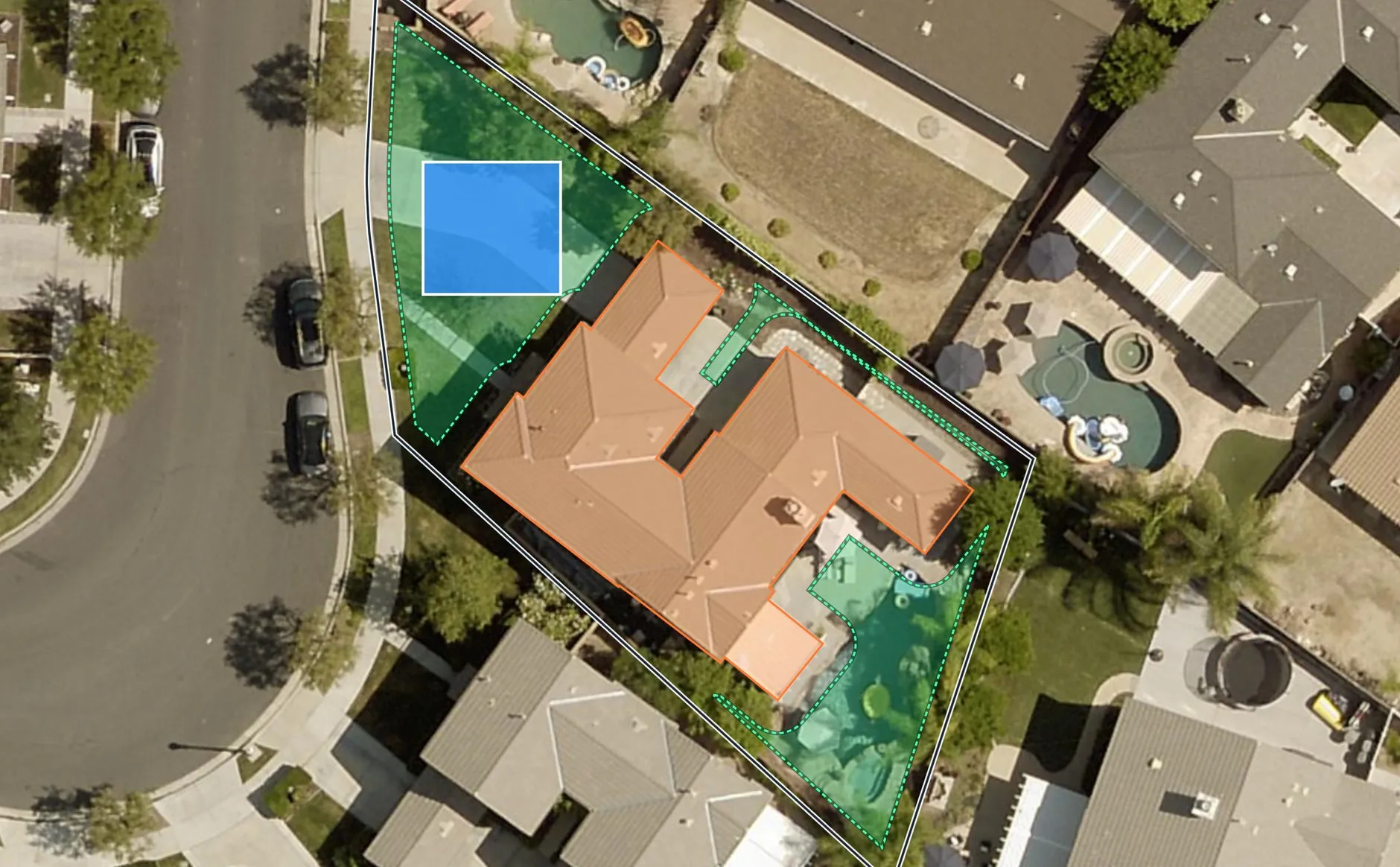 Aerial view of a real Temecula property. A white line traces the parcel boundary, the existing house is outlined in orange, the area left over after the city's setbacks is shaded green, and a blue rectangle shows a pre-approved ADU plan placed in the back yard.
